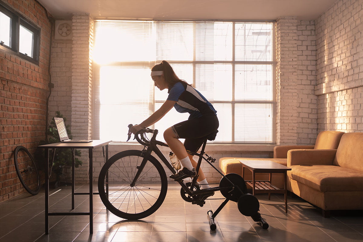woman with Parkinson's Disease riding a mobile bike inside her living room