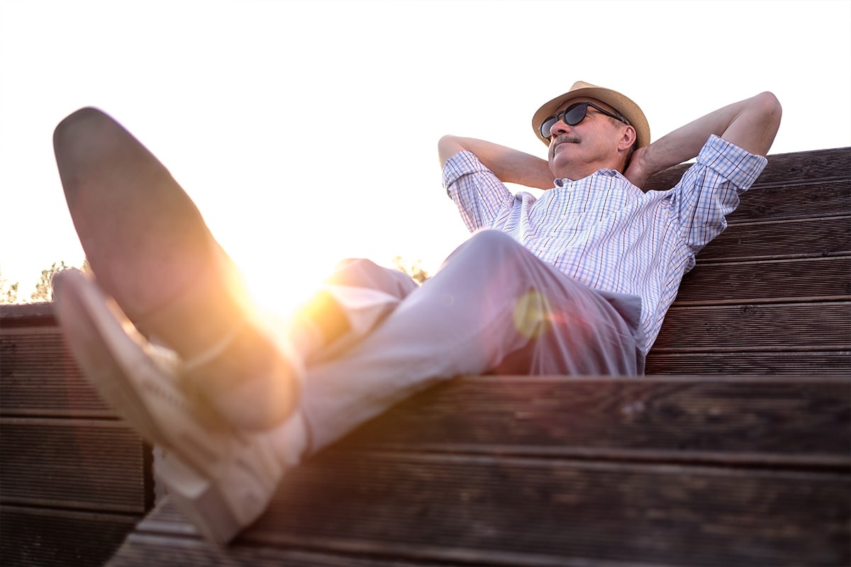 Man with Parkinson's Disease relaxing during a sunset