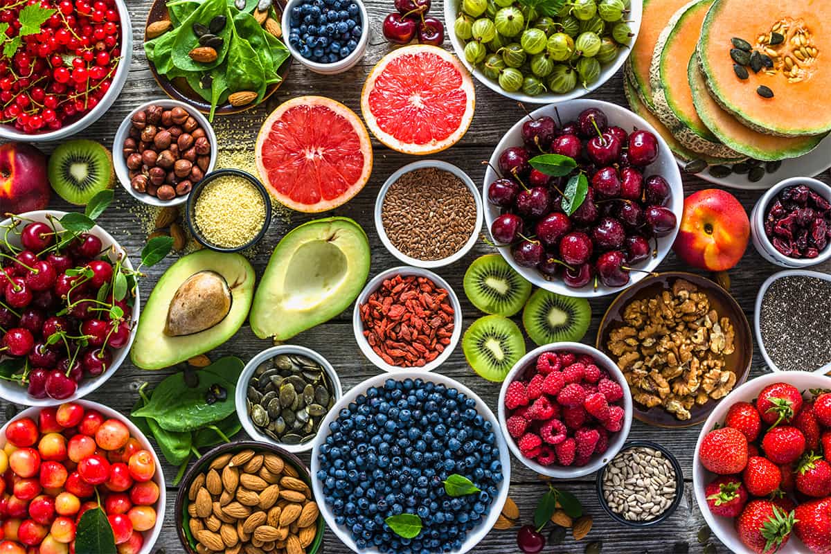 Selection of healthy food that are great to eat for someone with Parkinson's Disease. Superfoods, various fruits and assorted berries, nuts and seeds