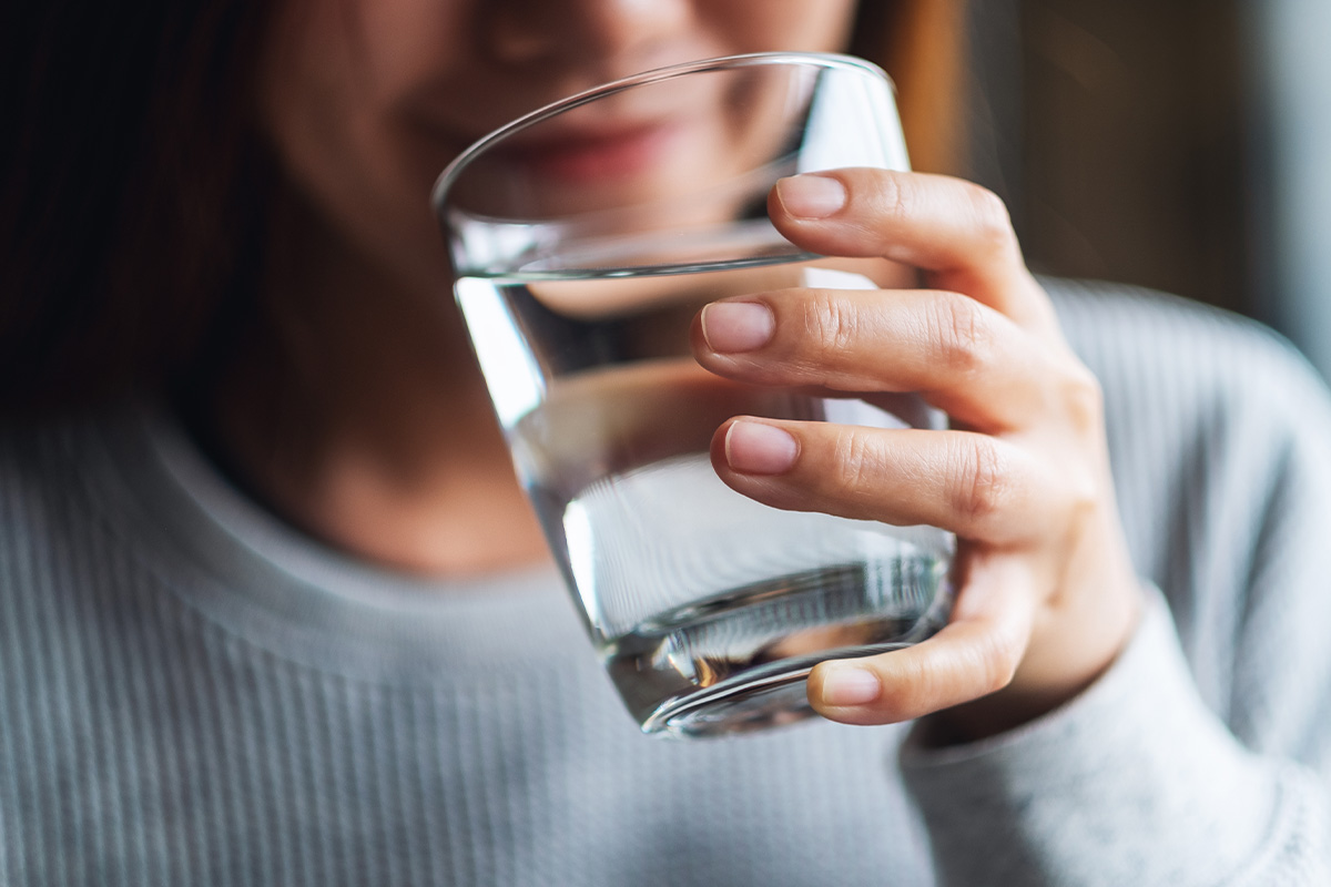 woman drinking a glass of water