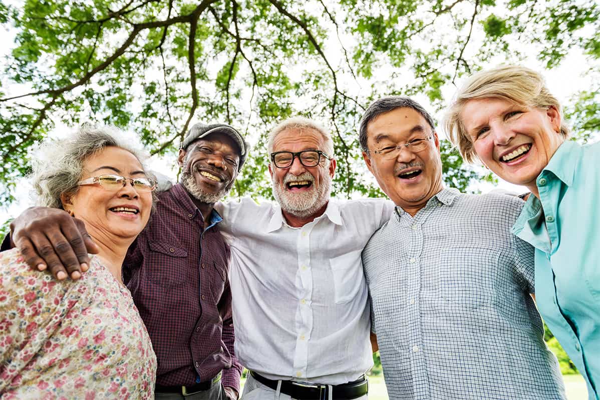 A diverse group of people that live with Parkinson's disease embracing one another