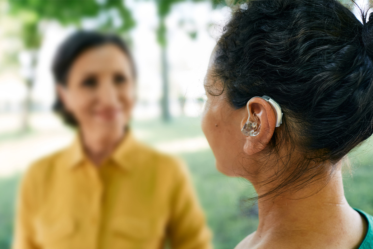 Woman smiling with a hearing aid