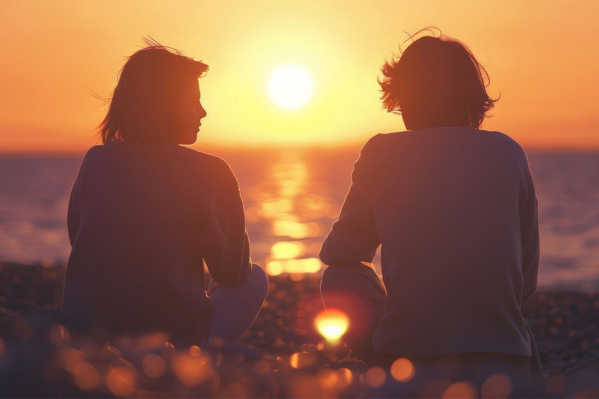 Two people sitting watching the sunset